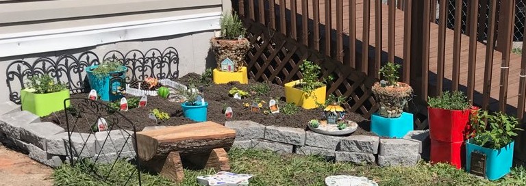 Fairies and flowers in the fairy garden.