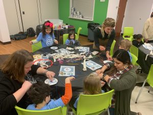 Early Educators and their students work on weaving skills.